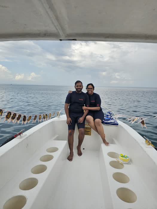 Two divers sitting together on the dive boat before a dive
